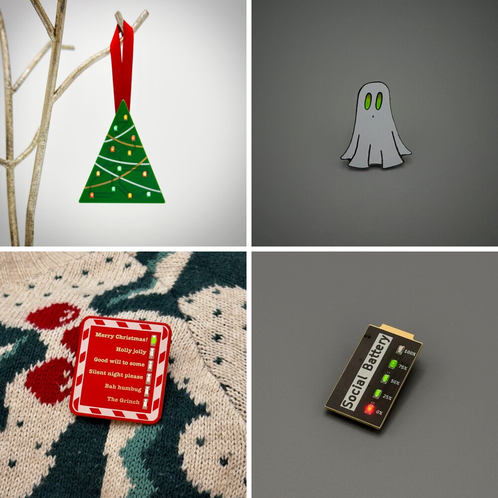 Four pin badges made in the workshop: a Christmas tree, a ghost, a festive badge, and the social battery badge.
